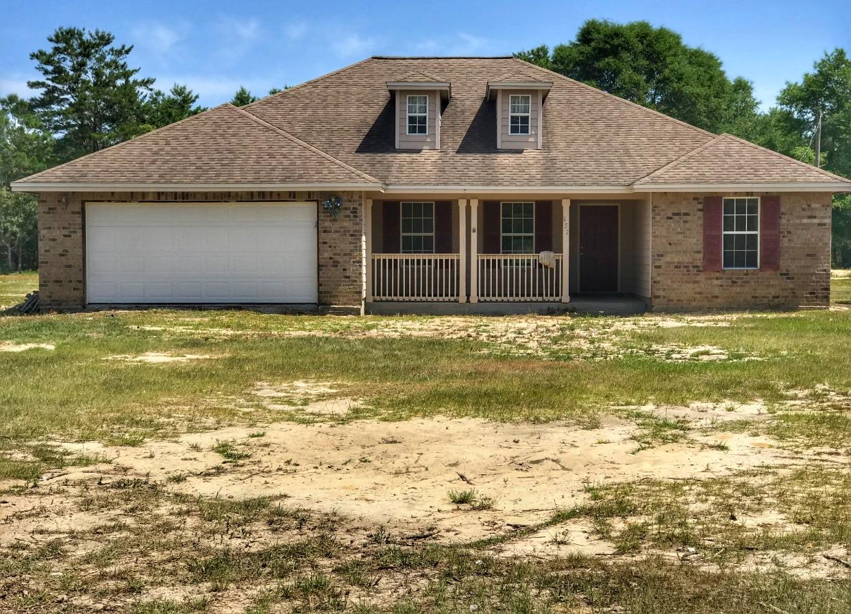657 Elmwood Road DeFuniak Springs, FL 32433 - Photo 1 of 15 a front view of a house with a yard