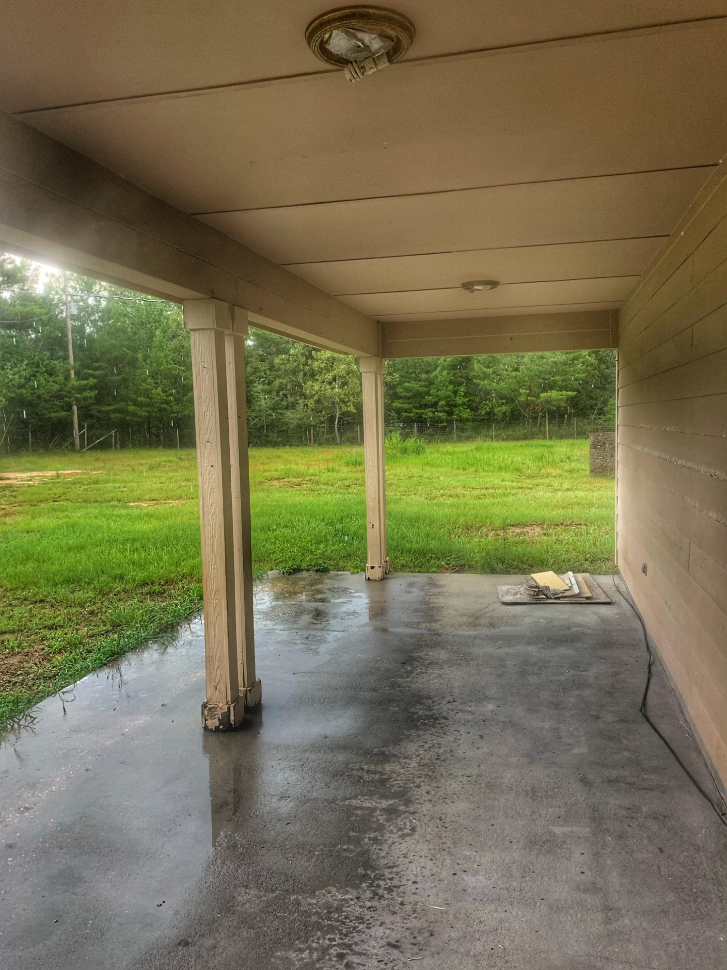 657 Elmwood Road DeFuniak Springs, FL 32433 - Photo 3 of 15 a view of a yard with porch and garden