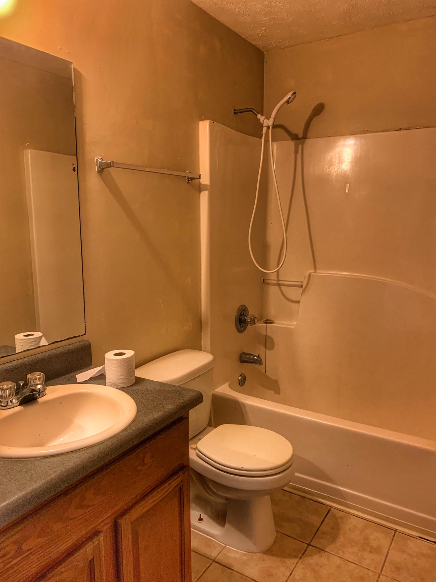 657 Elmwood Road DeFuniak Springs, FL 32433 - Photo 9 of 15 a bathroom with a sink a toilet and shower