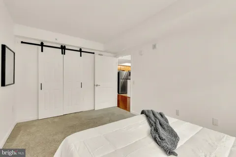 a bedroom with a bed and a lamp