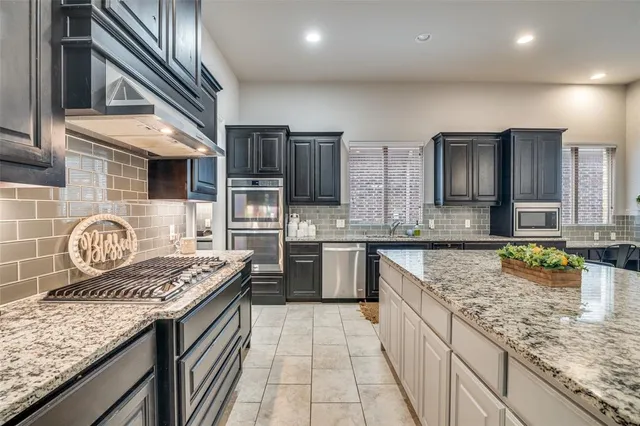 a large kitchen with a table and chairs