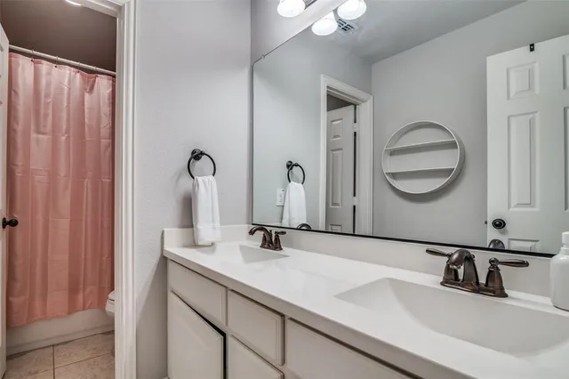a bedroom with a large bed and a ceiling fan
