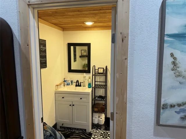 a bathroom with a sink mirror and toilet