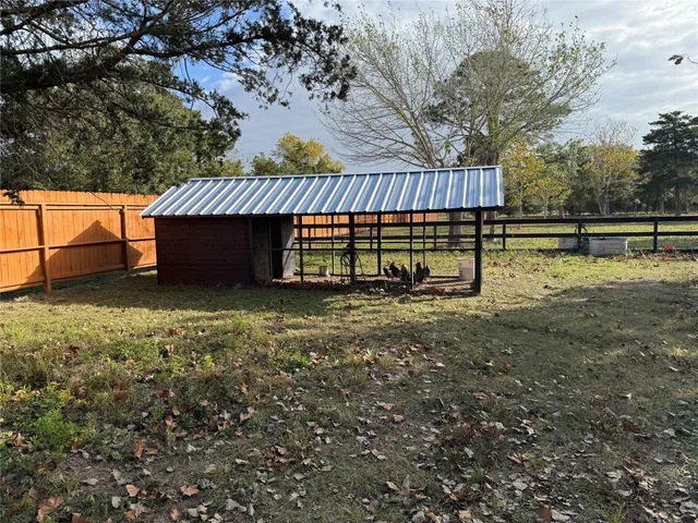 a view of a yard with wooden fence