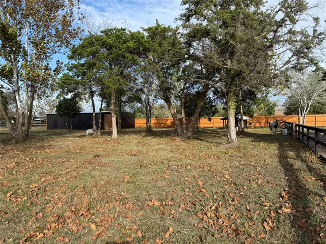 a view of outdoor space with green field and trees