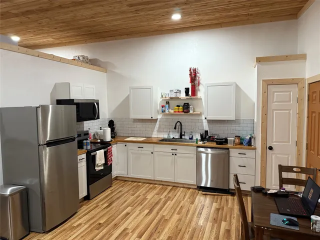a kitchen with cabinets a sink and appliances