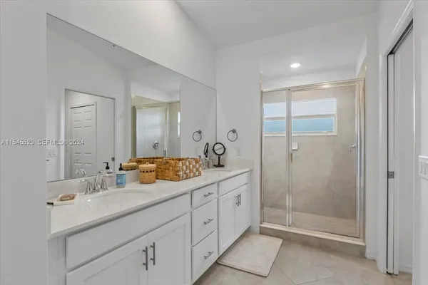 a spacious bathroom with a shower sink and toilet