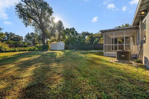 a view of a house with backyard and sitting area