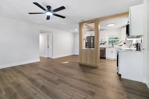 a view of a kitchen with a sink and a refrigerator