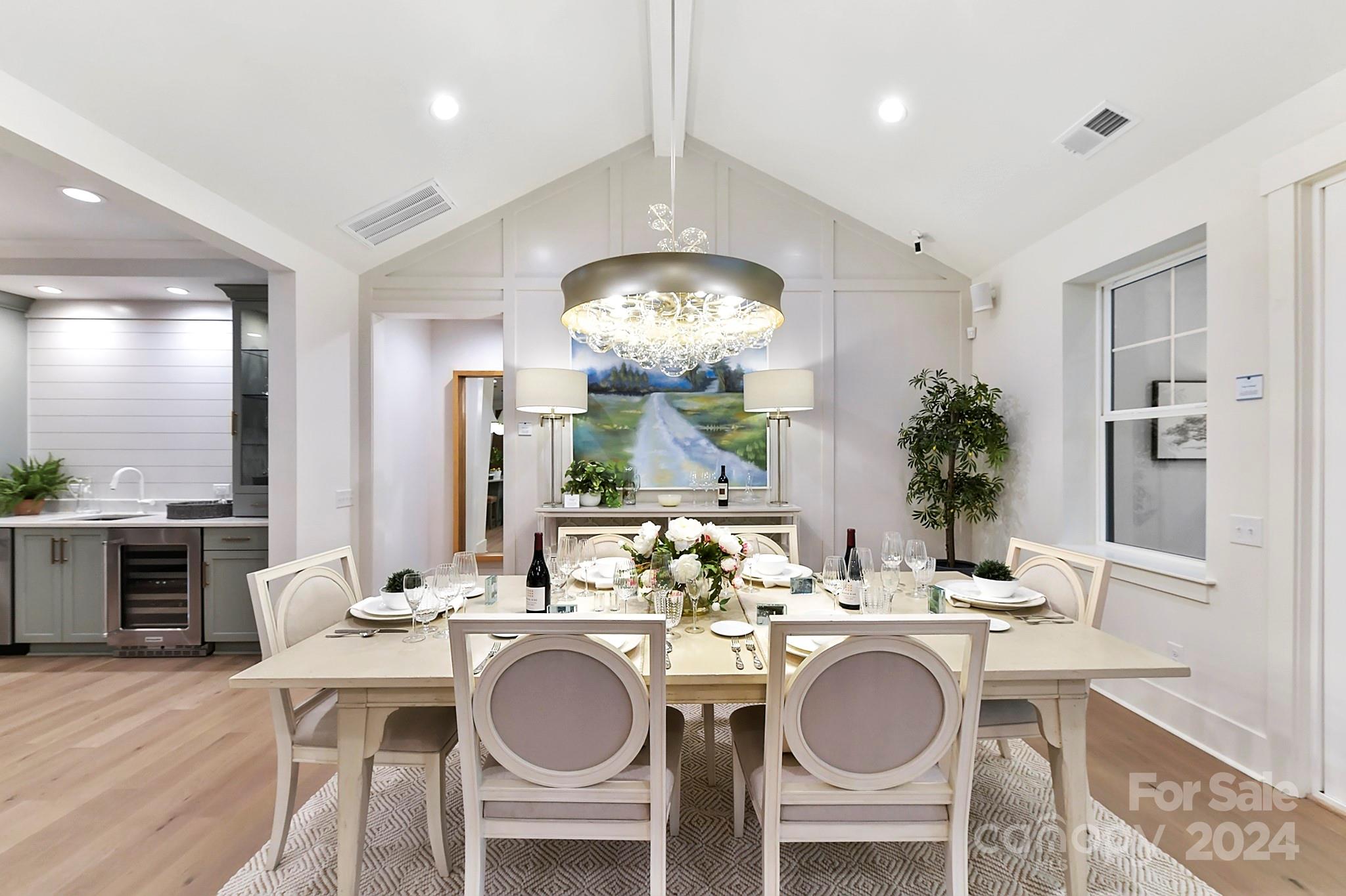 335 Bubbling Well Road Matthews, NC 28105 - Photo 12 of 48 a kitchen with a dining table chairs sink and stove