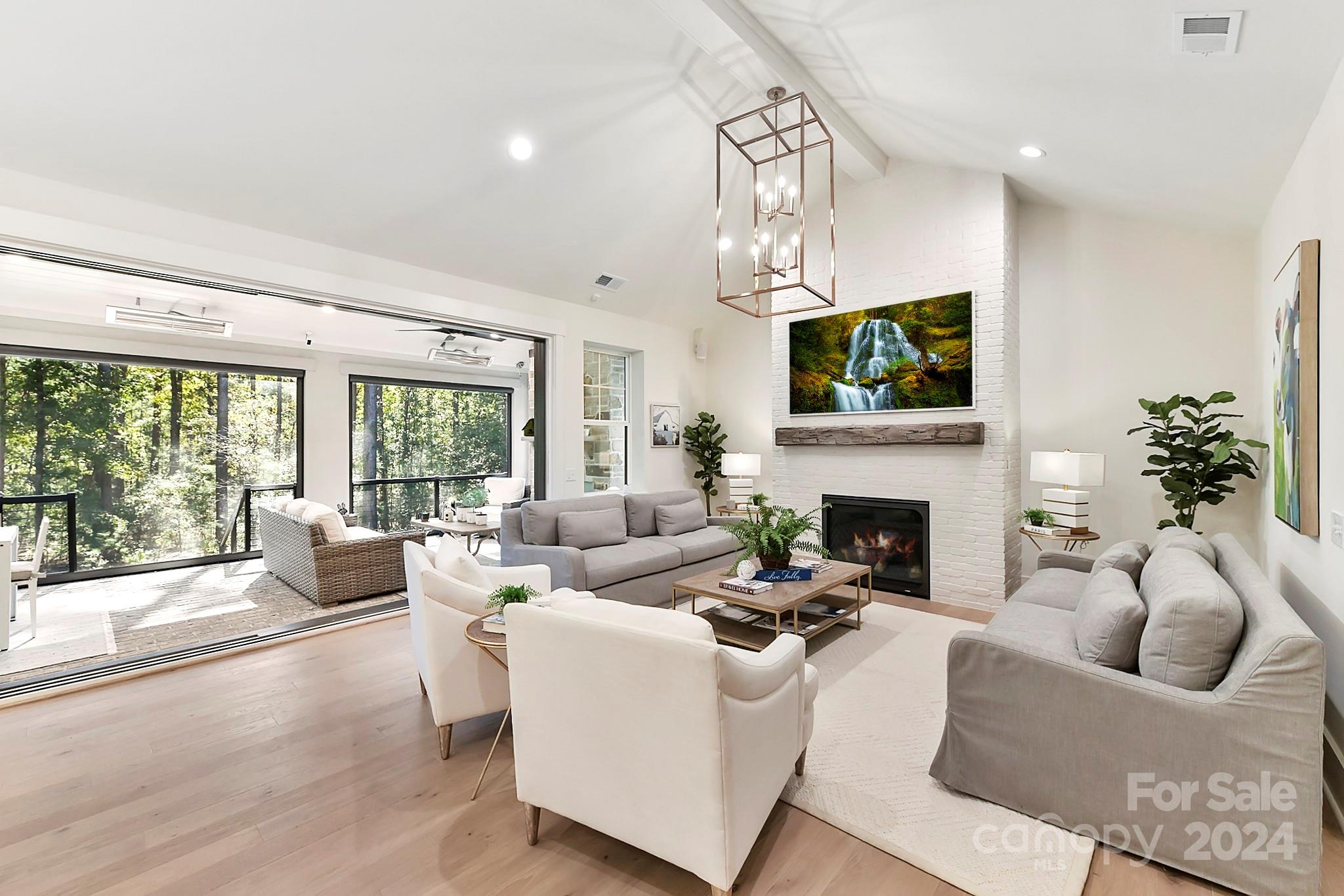 335 Bubbling Well Road Matthews, NC 28105 - Photo 13 of 48 a living room with furniture a fireplace and a flat screen tv