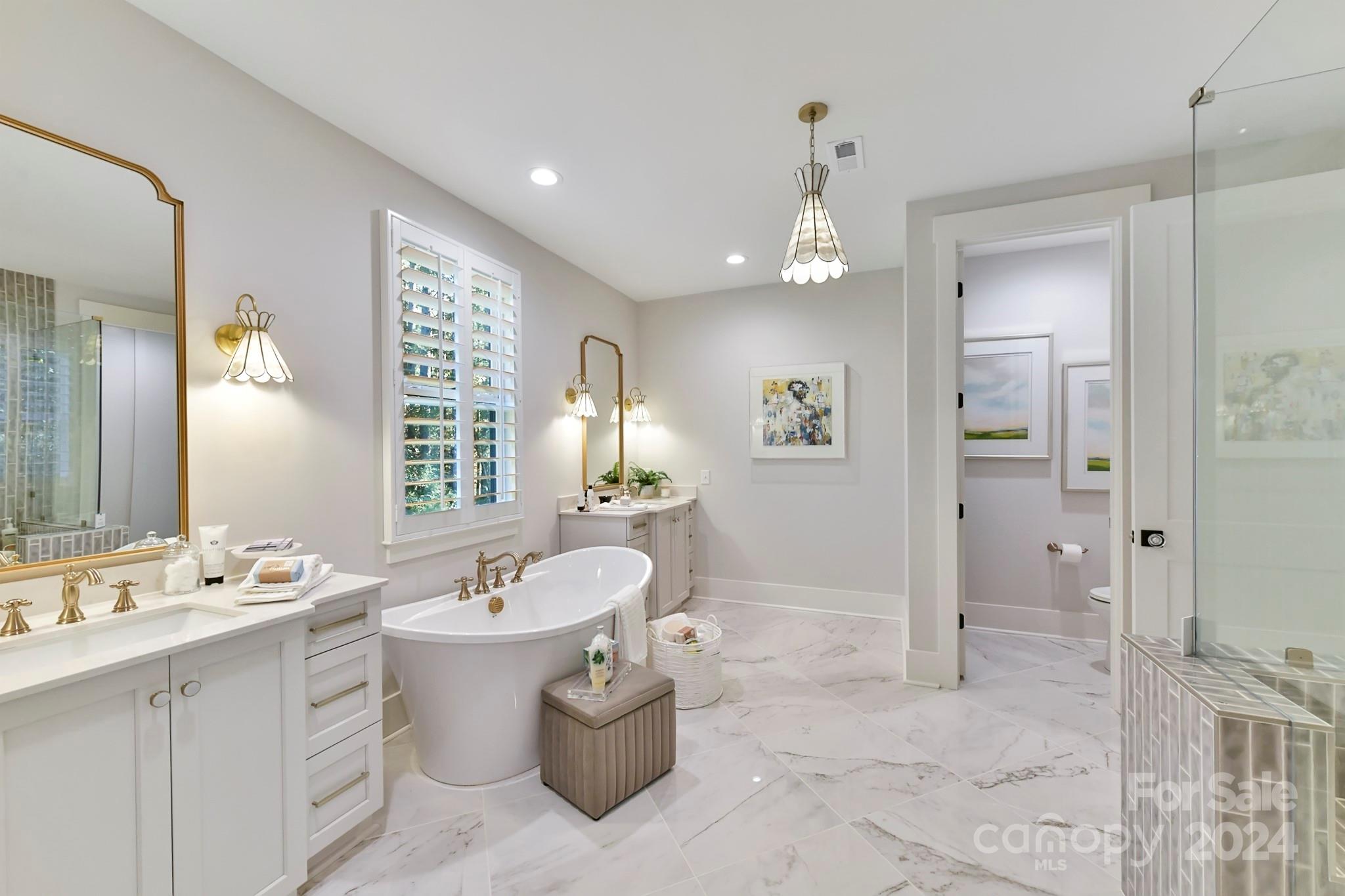 335 Bubbling Well Road Matthews, NC 28105 - Photo 20 of 48 a bathroom with a sink a faucet a mirror and a bathtub