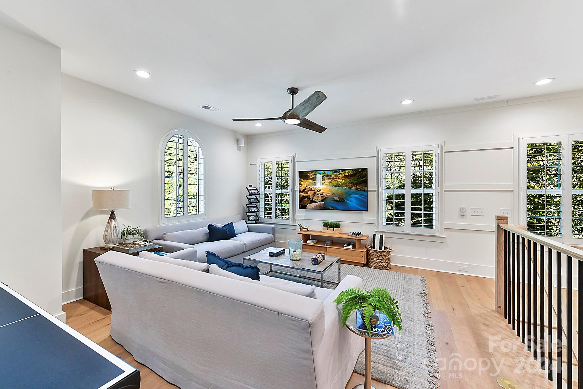 335 Bubbling Well Road Matthews, NC 28105 - Photo 30 of 48 a living room with furniture a large window and a flat screen tv