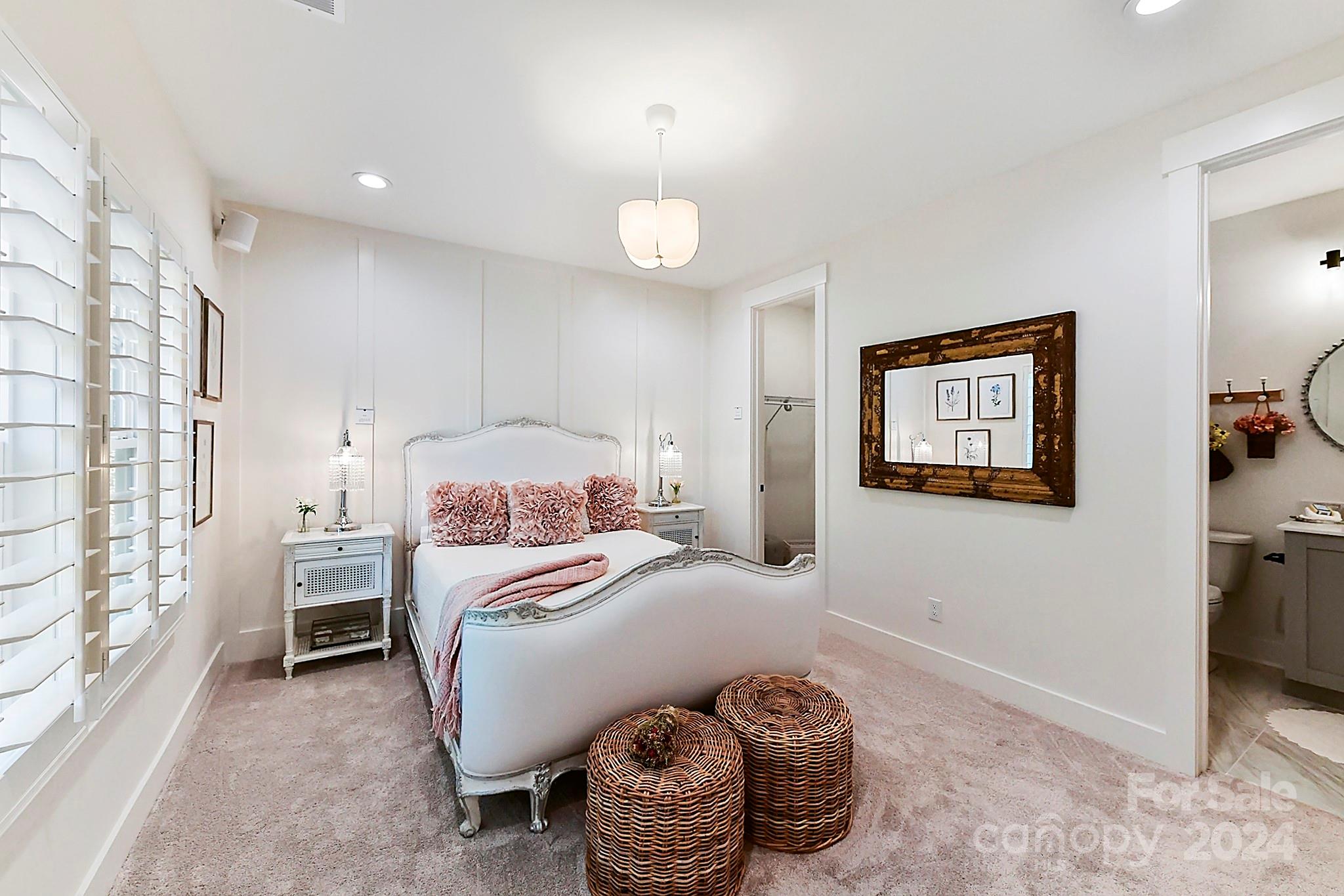 335 Bubbling Well Road Matthews, NC 28105 - Photo 34 of 48 a bedroom with a bed and a chandelier