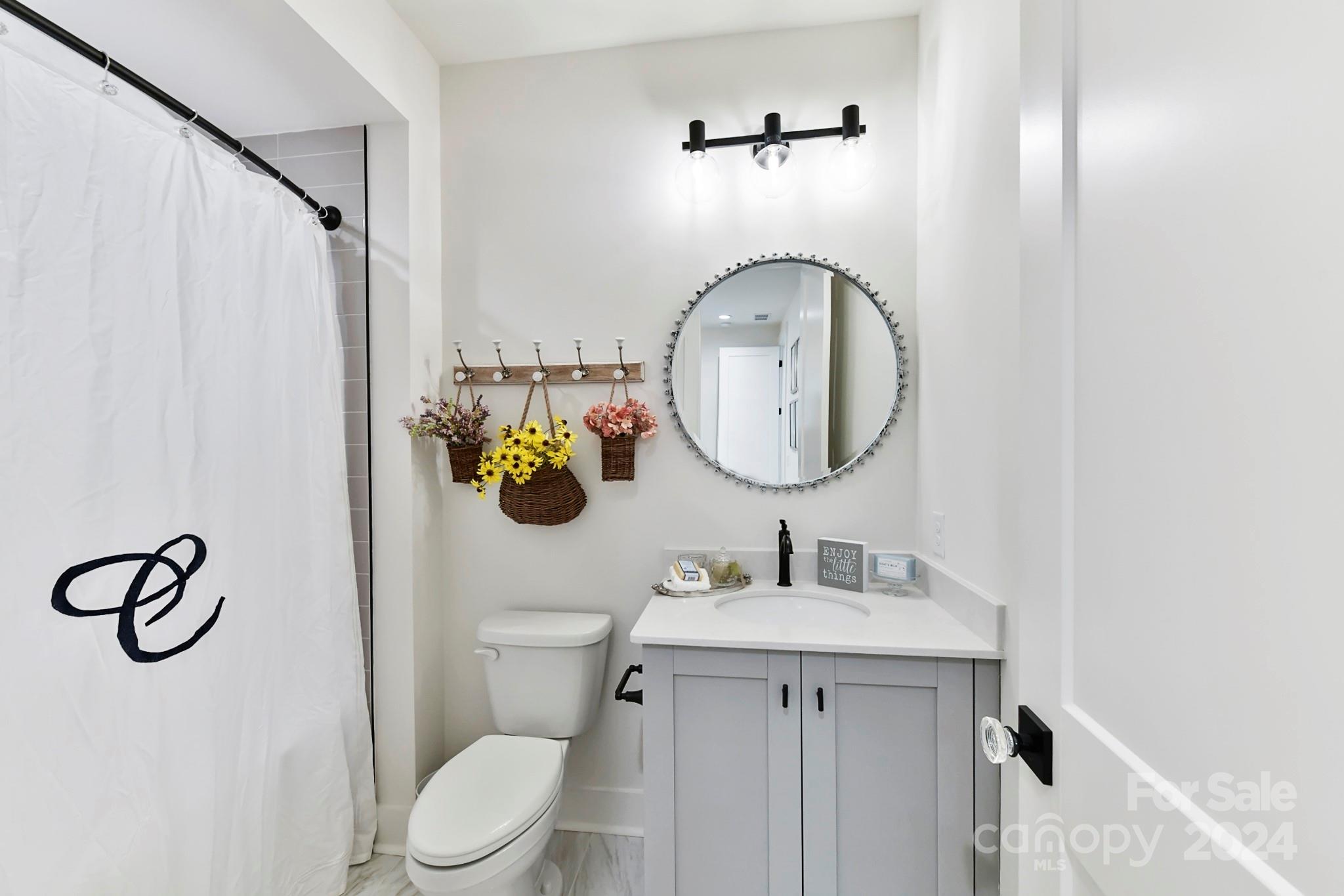 335 Bubbling Well Road Matthews, NC 28105 - Photo 36 of 48 a bathroom with a sink vanity mirror and toilet