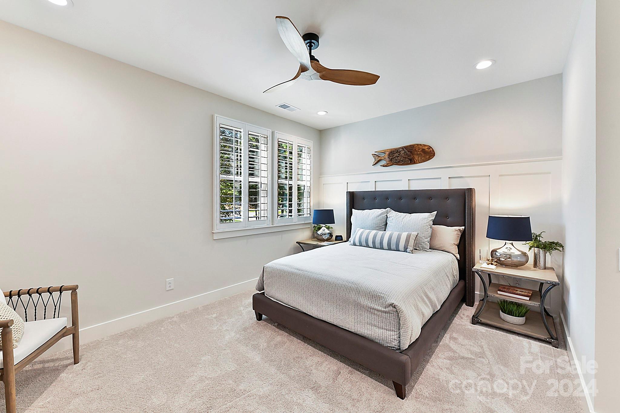 335 Bubbling Well Road Matthews, NC 28105 - Photo 37 of 48 a spacious bedroom with a bed a window and a chandelier