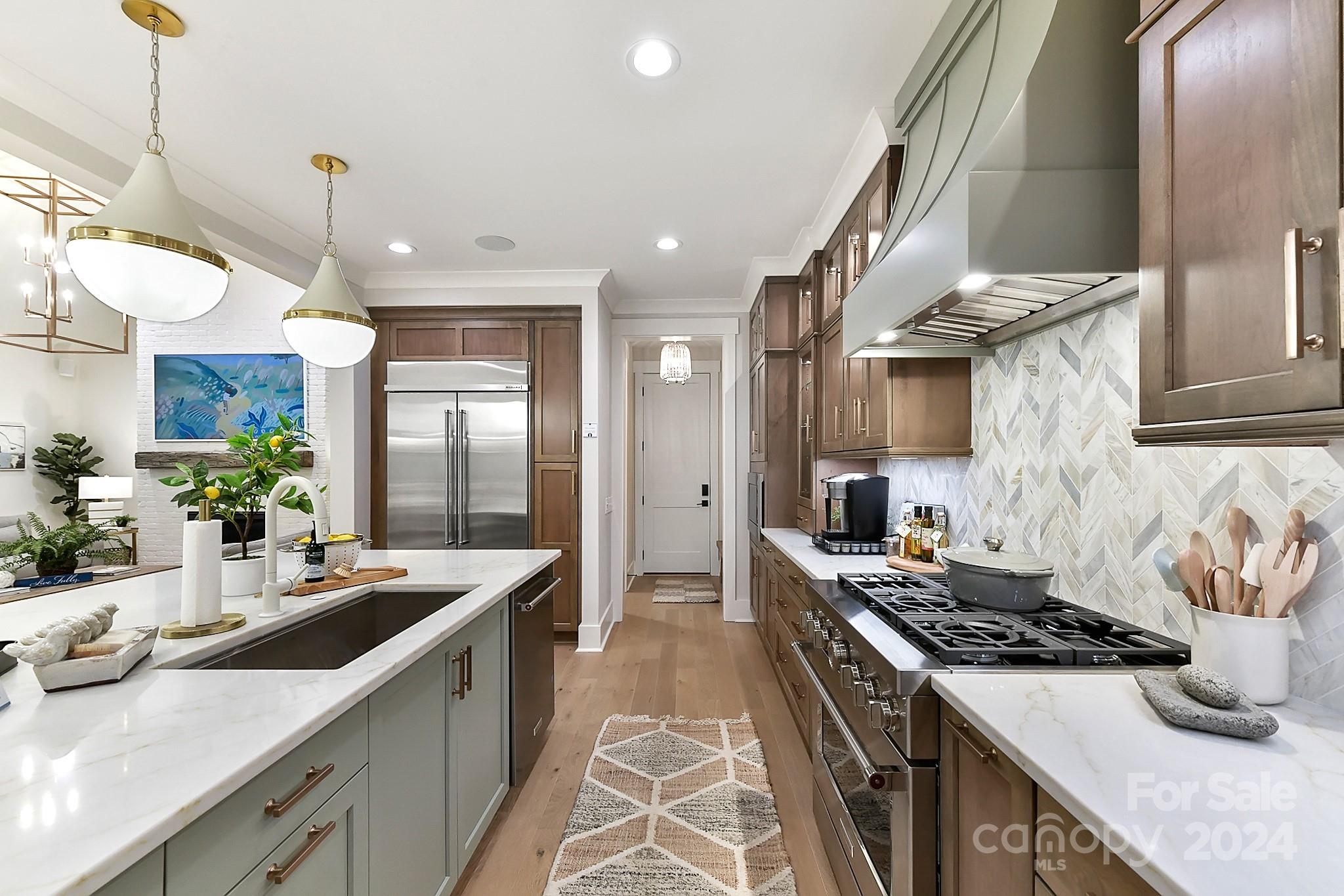 335 Bubbling Well Road Matthews, NC 28105 - Photo 7 of 48 a kitchen with stainless steel appliances granite countertop a sink stove and refrigerator