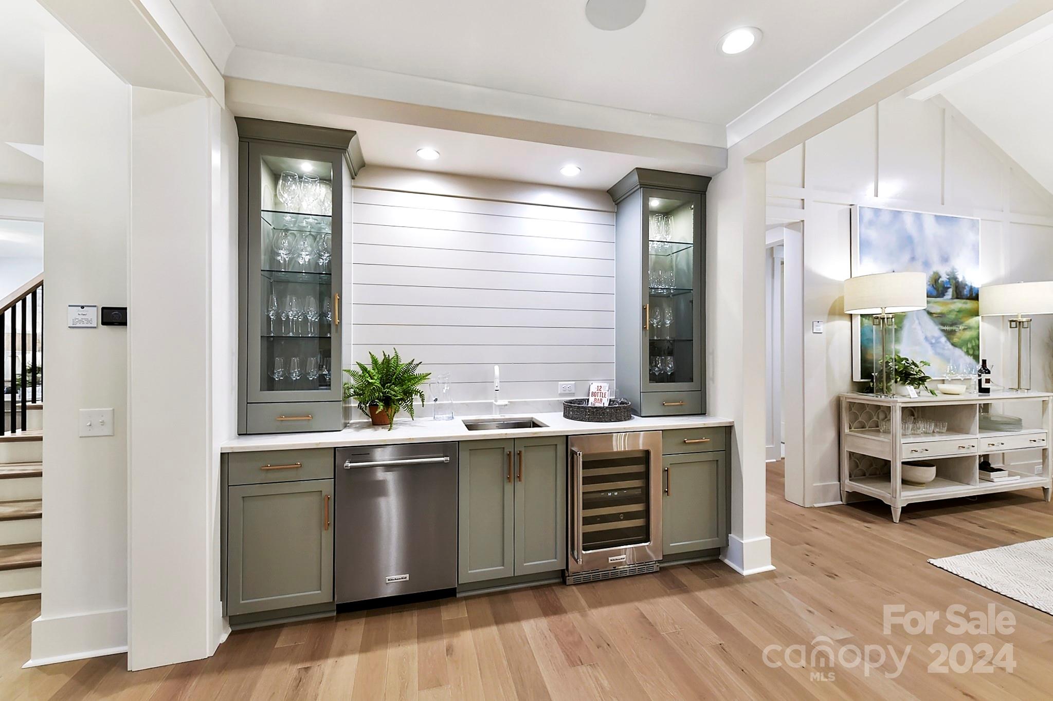 335 Bubbling Well Road Matthews, NC 28105 - Photo 9 of 48 a kitchen with stainless steel appliances a sink and wooden floor