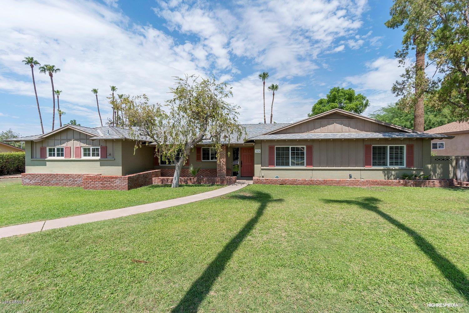 3424 East Camelback Road Phoenix, AZ 85018 - Photo 1 of 27 a front view of a house with a yard table and chairs