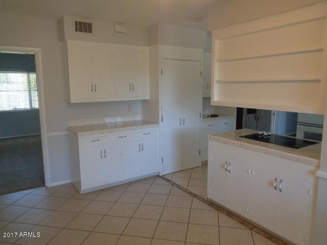 3424 East Camelback Road Phoenix, AZ 85018 - Photo 18 of 27 a kitchen with a sink and cabinets