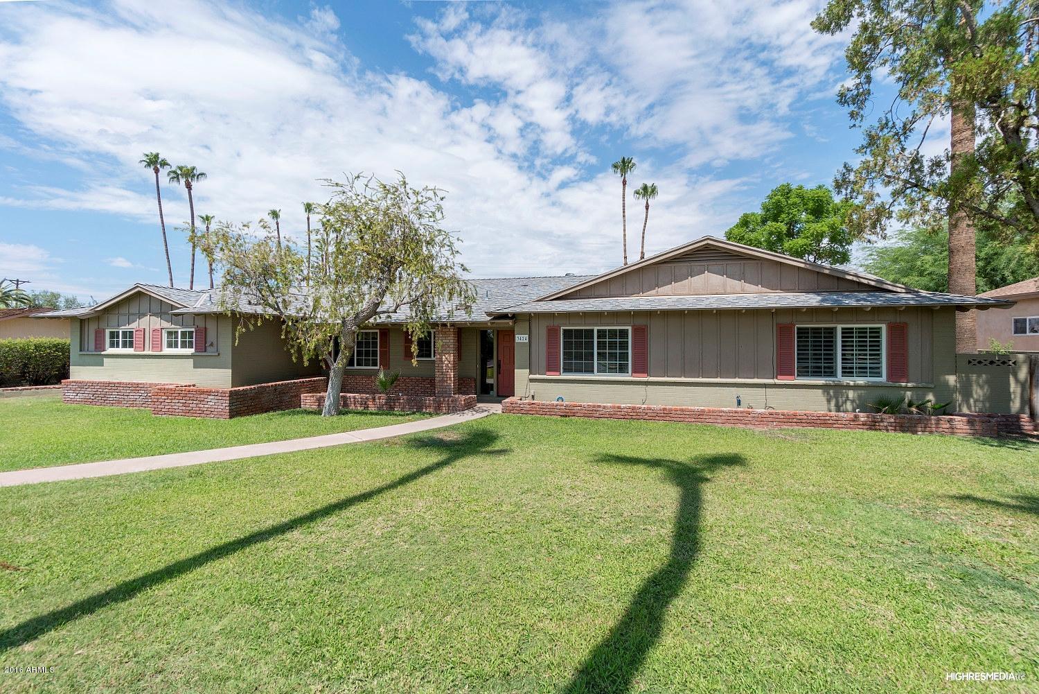 3424 East Camelback Road Phoenix, AZ 85018 - Photo 2 of 27 a front view of a house with a garden and trees
