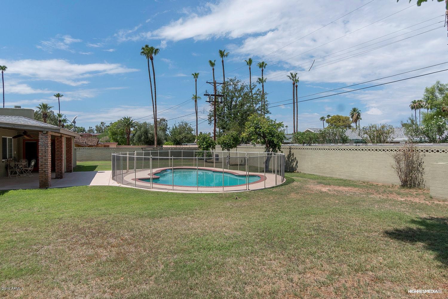 3424 East Camelback Road Phoenix, AZ 85018 - Photo 25 of 27 a view of a swimming pool with a yard