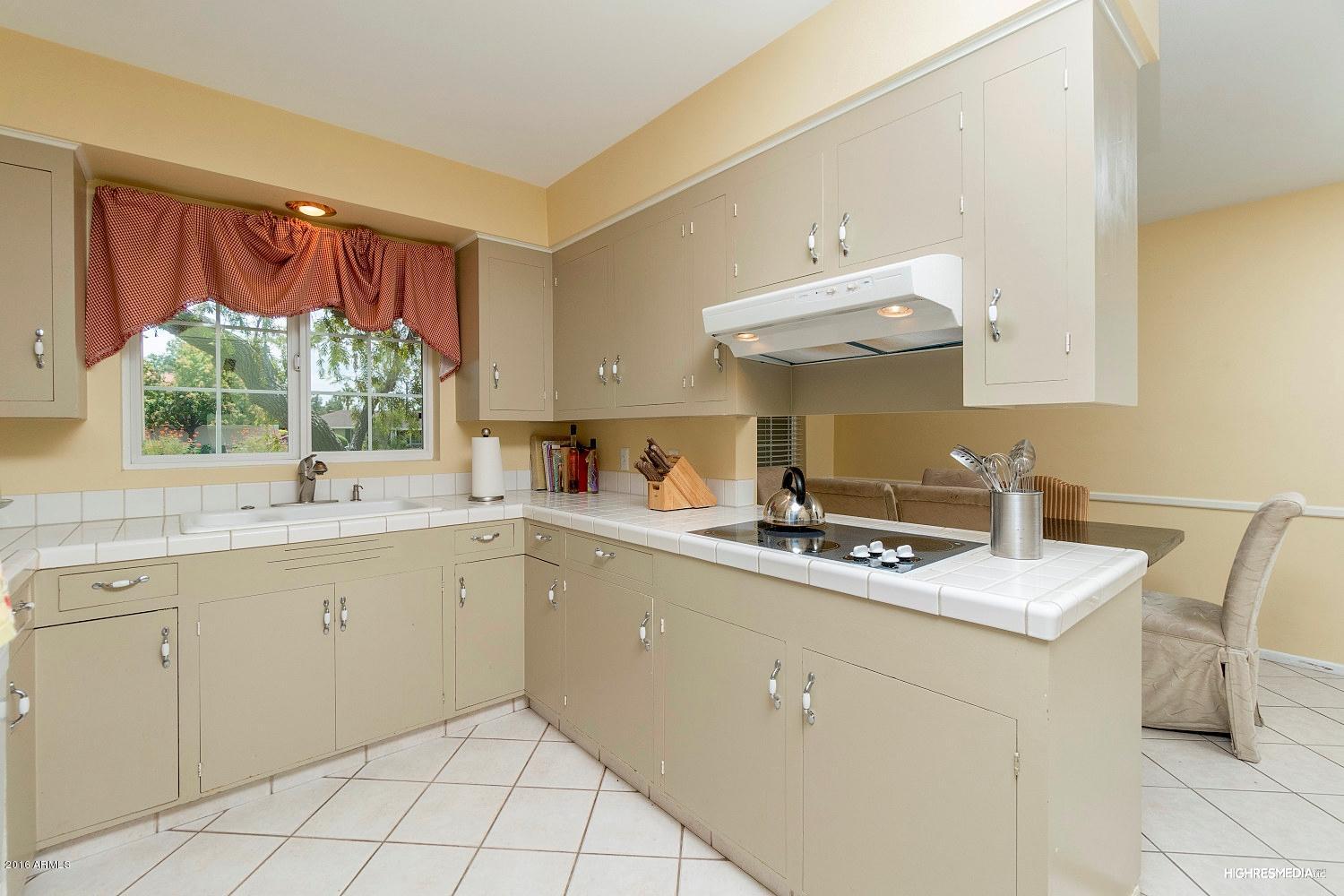 3424 East Camelback Road Phoenix, AZ 85018 - Photo 4 of 27 a kitchen with a sink window and cabinets