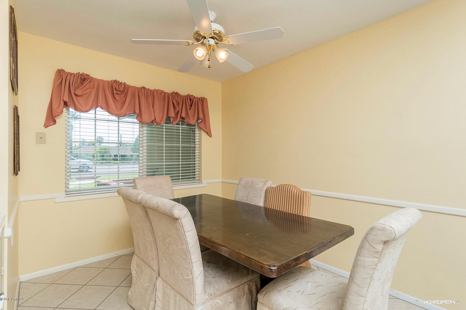 3424 East Camelback Road Phoenix, AZ 85018 - Photo 5 of 27 a view of a dining room with furniture and a chandelier