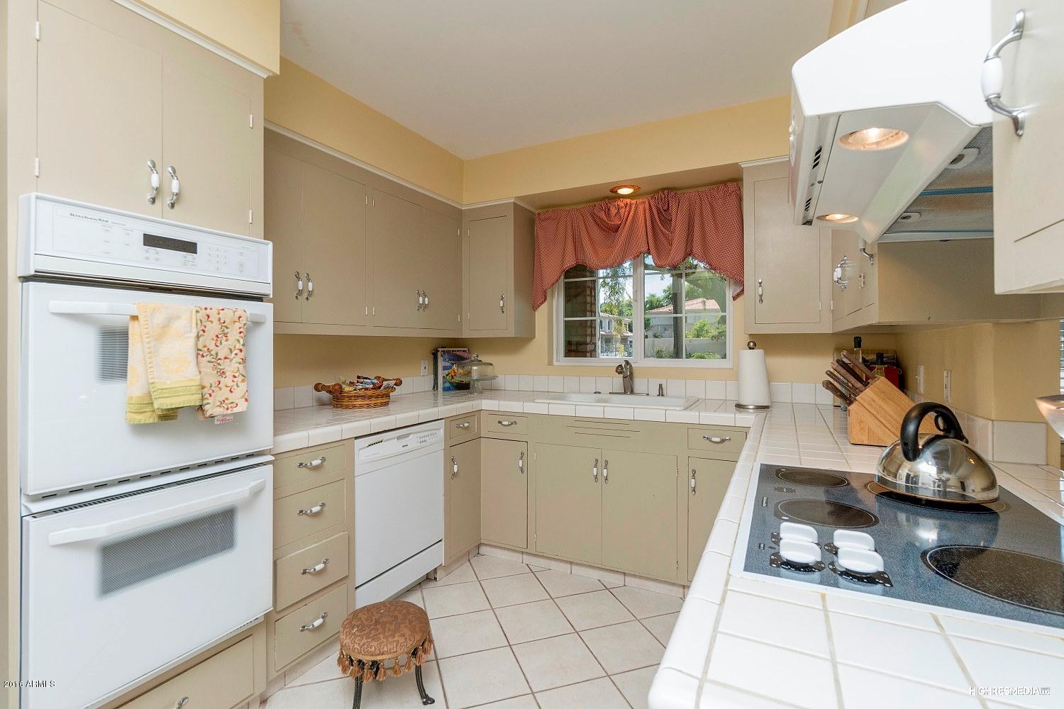 3424 East Camelback Road Phoenix, AZ 85018 - Photo 6 of 27 a kitchen with a sink cabinets and window
