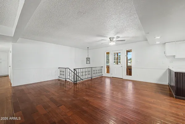 a kitchen with stainless steel appliances a sink cabinets and wooden floor