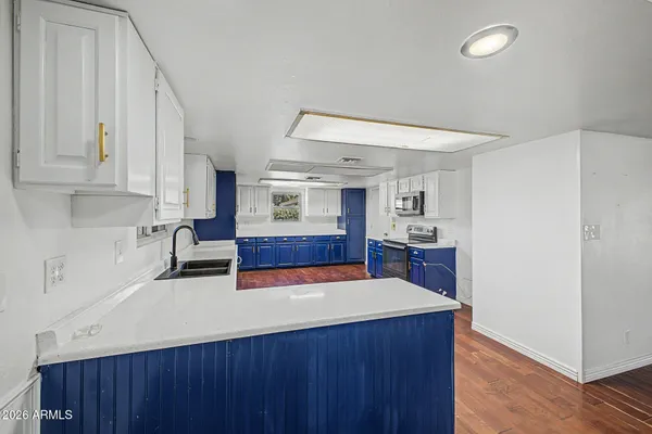 a kitchen with wooden floors and wooden cabinets