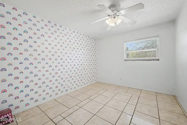 a spacious bathroom with a granite countertop sink a toilet and a mirror