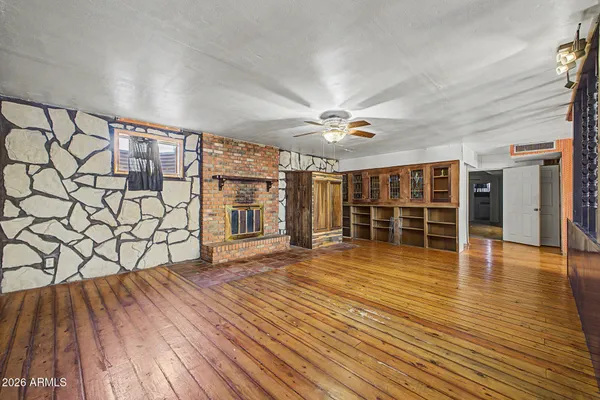 a view of a room with wooden floor