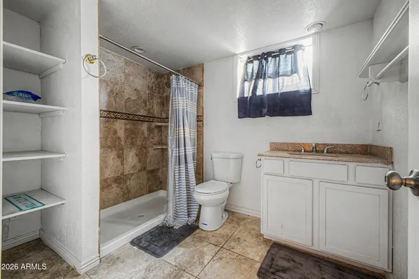 a kitchen with a sink cabinets and wooden floor