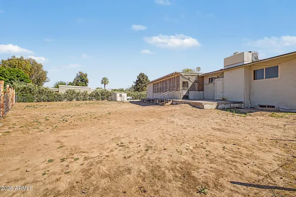 an aerial view of a house with a yard and lake