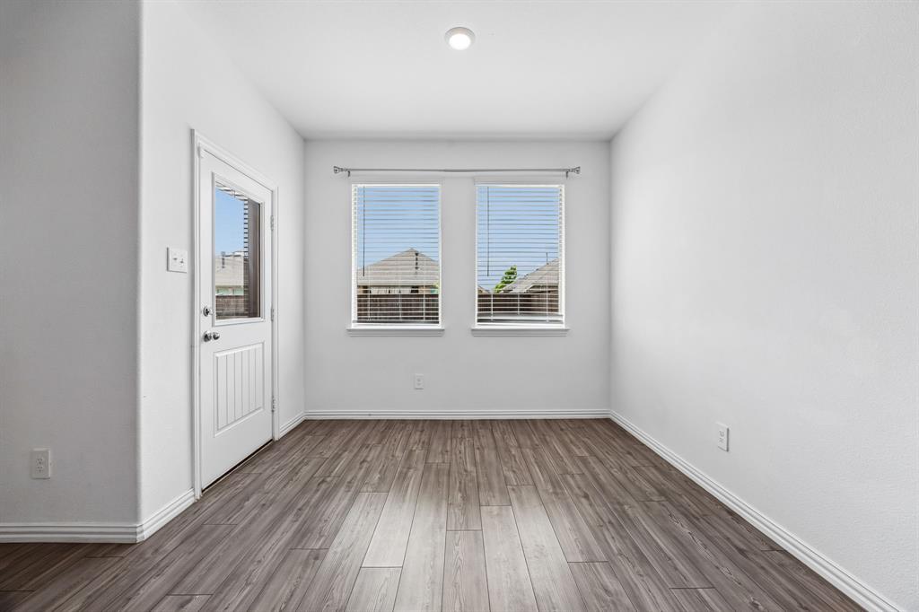 820 Carmen Street Forney, TX 75126 - Photo 11 of 25 wooden floor in an empty room with a window
