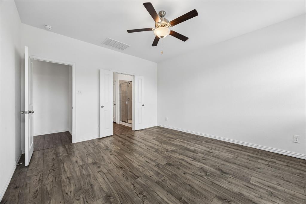 820 Carmen Street Forney, TX 75126 - Photo 13 of 25 an empty room with wooden floor and ceiling fan