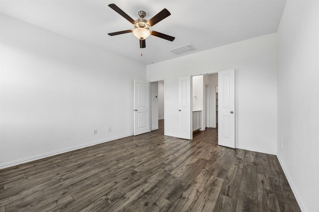 820 Carmen Street Forney, TX 75126 - Photo 14 of 25 an empty room with wooden floor and a ceiling fan