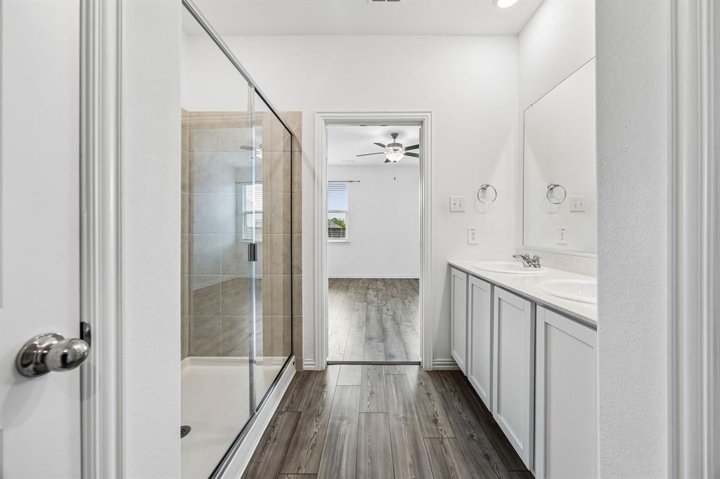 820 Carmen Street Forney, TX 75126 - Photo 16 of 25 a bathroom with a shower and a tub