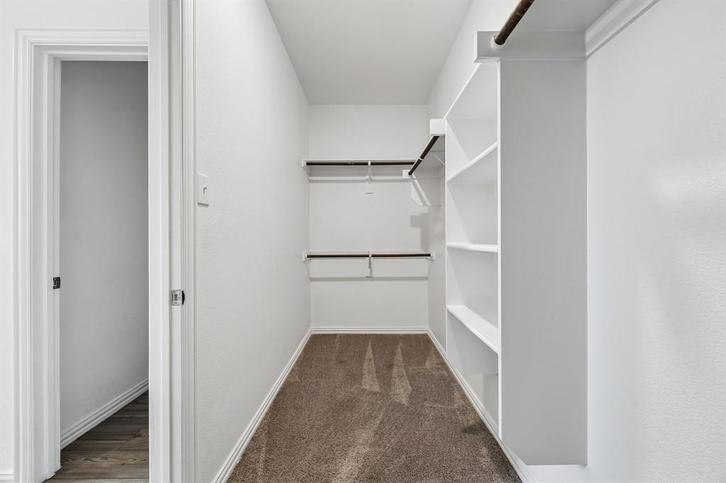 820 Carmen Street Forney, TX 75126 - Photo 18 of 25 a view of a hallway with wooden floor and staircase
