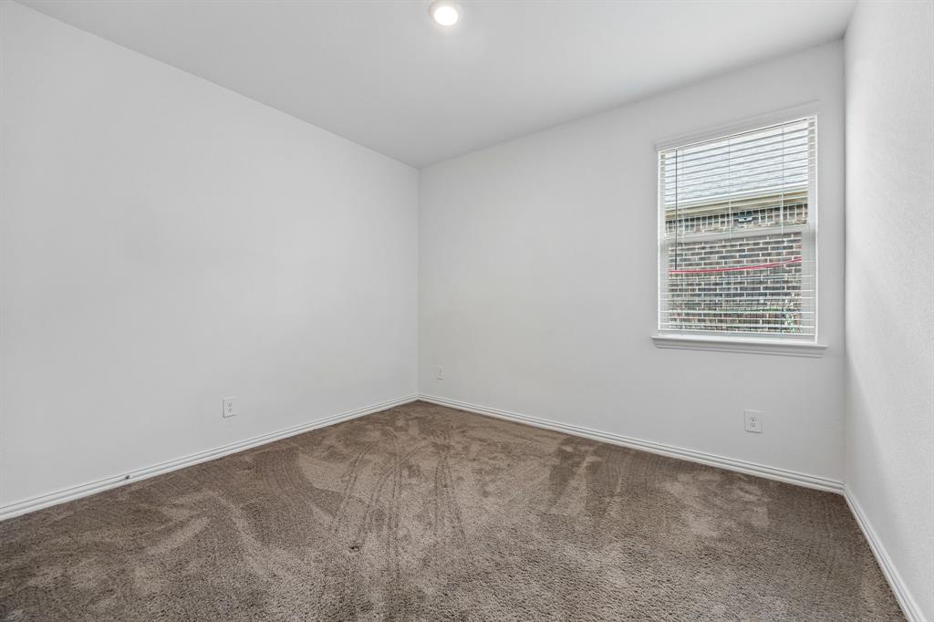 820 Carmen Street Forney, TX 75126 - Photo 19 of 25 an empty room with a window