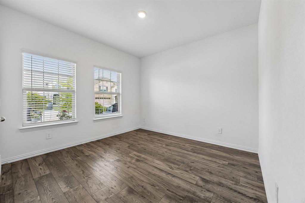 820 Carmen Street Forney, TX 75126 - Photo 20 of 25 an empty room with wooden floor and windows