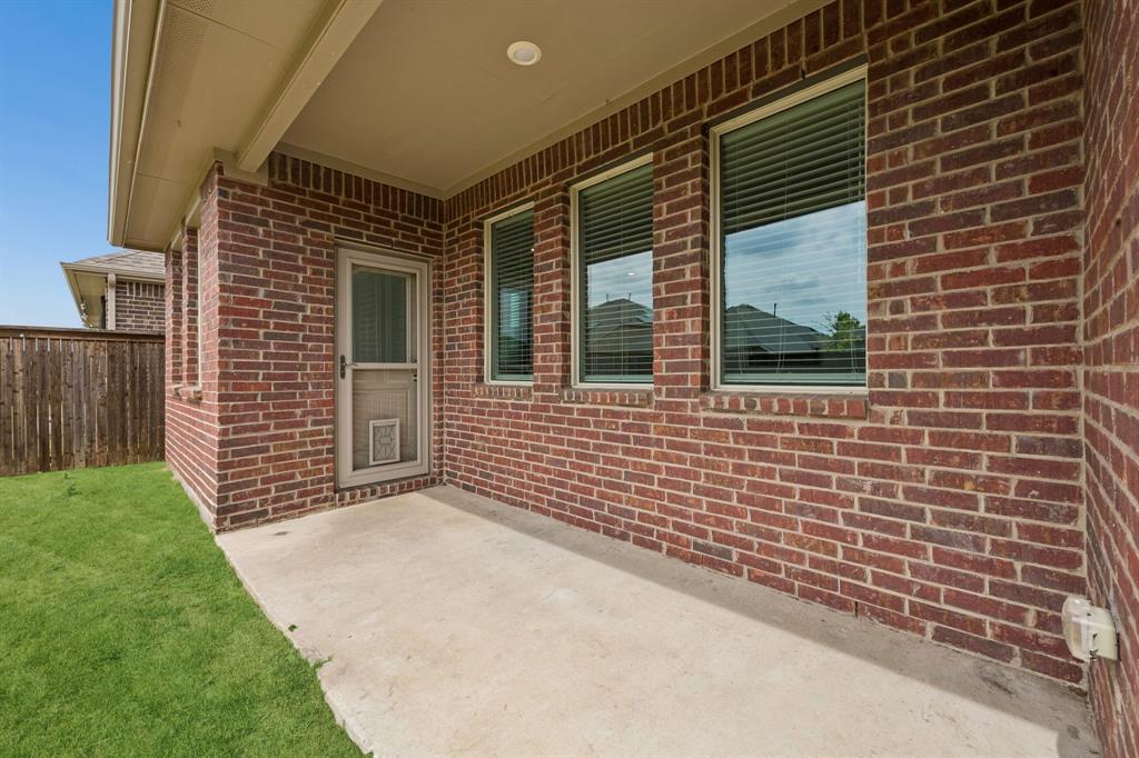 820 Carmen Street Forney, TX 75126 - Photo 23 of 25 a view of a brick house with a yard