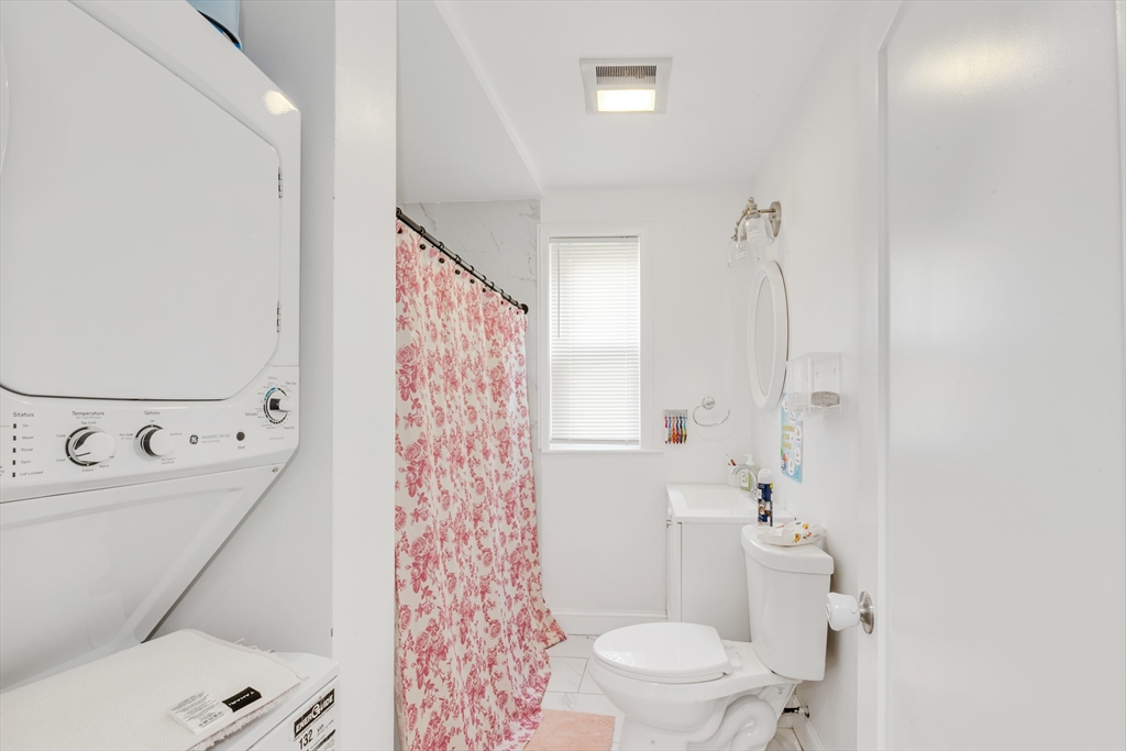 36 Brookledge Street Boston, MA 02121 - Photo 5 of 31 a bathroom with a sink a toilet and shower curtain