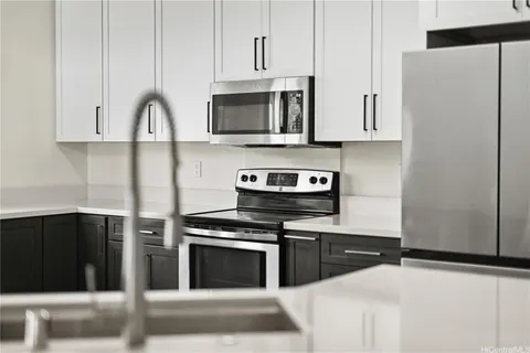 a kitchen with stainless steel appliances a stove a microwave and a refrigerator