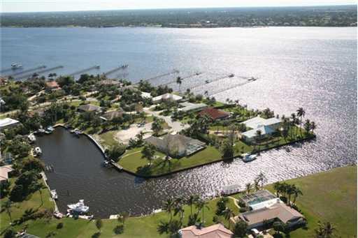 120 Northwest S Shore Road Stuart, FL 34994 - Photo 1 of 16 an aerial view of ocean with residential house and outdoor space