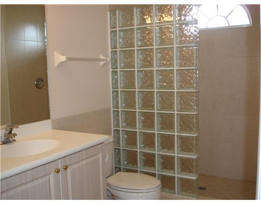 120 Northwest S Shore Road Stuart, FL 34994 - Photo 12 of 16 a bathroom with a sink a toilet and a mirror
