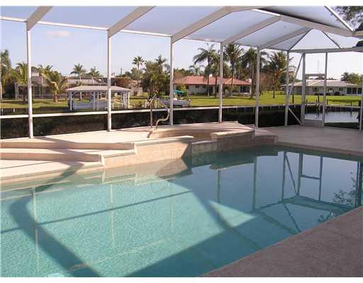 120 Northwest S Shore Road Stuart, FL 34994 - Photo 15 of 16 a view of a swimming pool with a bench in patio
