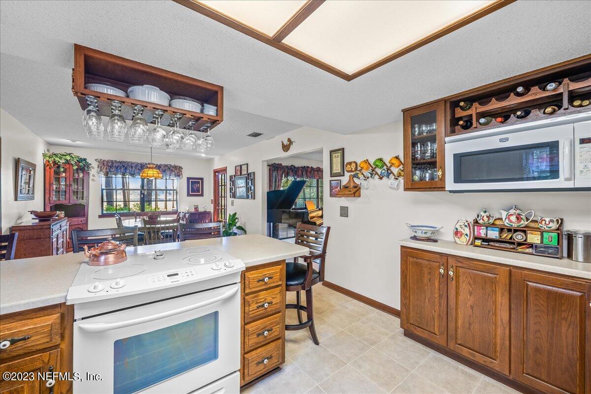 121 Peniel Church Road Palatka, FL 32177 - Photo 31 of 81 a kitchen that has a lot of cabinets a island and appliances in it