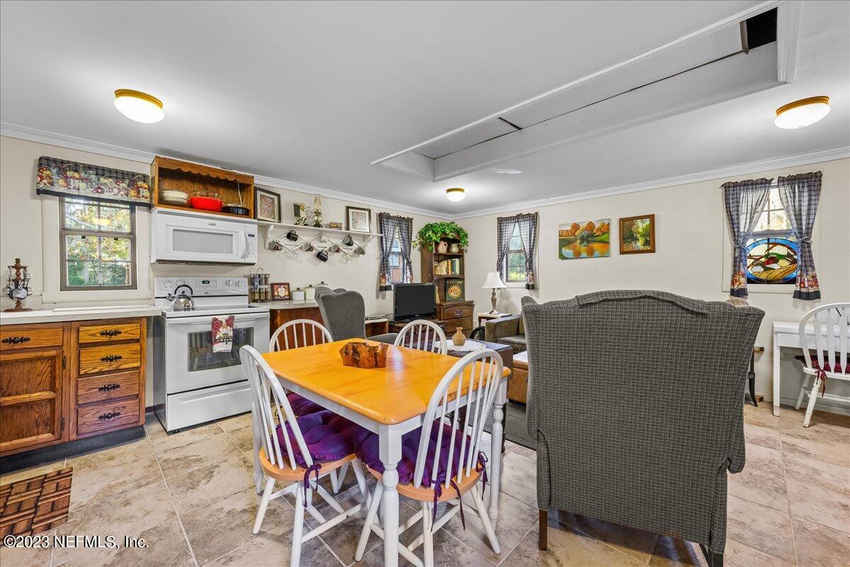 121 Peniel Church Road Palatka, FL 32177 - Photo 49 of 81 a living room with furniture a flat screen tv and a refrigerator